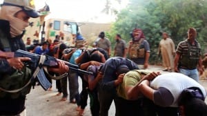 This image posted on a militant website on Saturday, June 14, 2014, which has been verified and is consistent with other AP reporting, appears to show militants from the al-Qaida-inspired Islamic State of Iraq and the Levant (ISIL) leading away captured Iraqi soldiers dressed in plain clothes after taking over a base in Tikrit, Iraq. The Islamic militant group that seized much of northern Iraq has posted photos that appear to show its fighters shooting dead dozens of captured Iraqi soldiers in a province north of the capital Baghdad. Iraq's top military spokesman Lt. Gen. Qassim al-Moussawi confirmed the photosí authenticity on Sunday and said he was aware of cases of mass murder of Iraqi soldiers. (AP Photo via militant website)